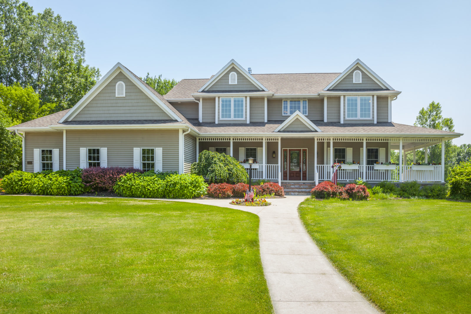 A large house with a lawn and garden.